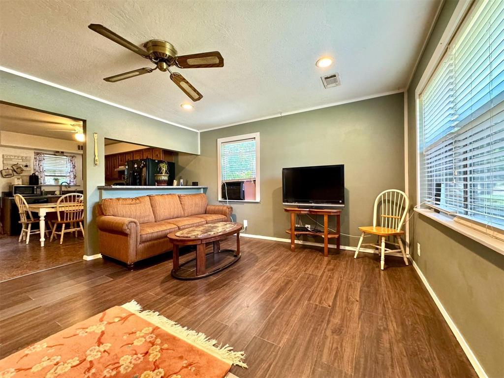 1319 West Morgan Street Denison, TX 75020 - Photo 2 of 17 a living room with furniture and a flat screen tv