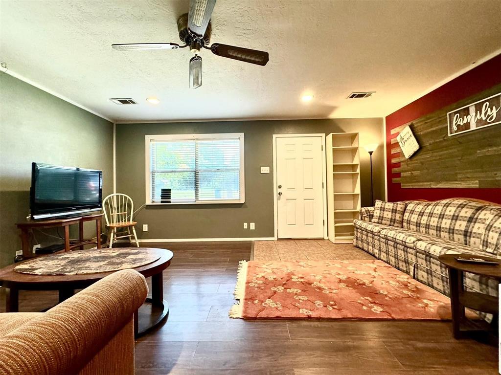 1319 West Morgan Street Denison, TX 75020 - Photo 3 of 17 a living room with furniture and a flat screen tv