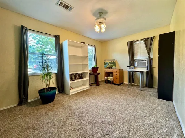 a view of a livingroom with furniture and a flat screen tv