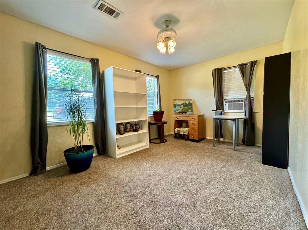 1319 West Morgan Street Denison, TX 75020 - Photo 10 of 17 a view of a livingroom with furniture and a flat screen tv