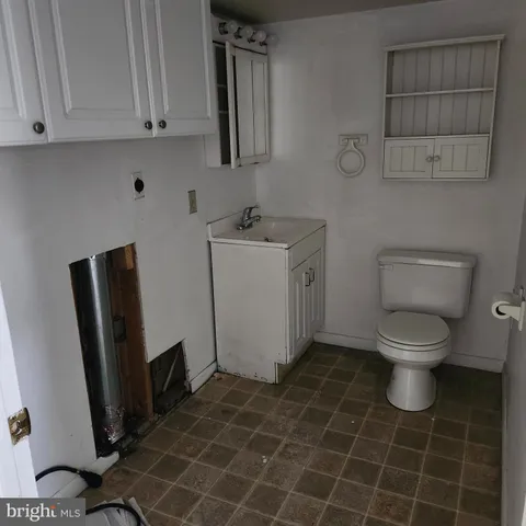 a bathroom with a sink a toilet and a mirror