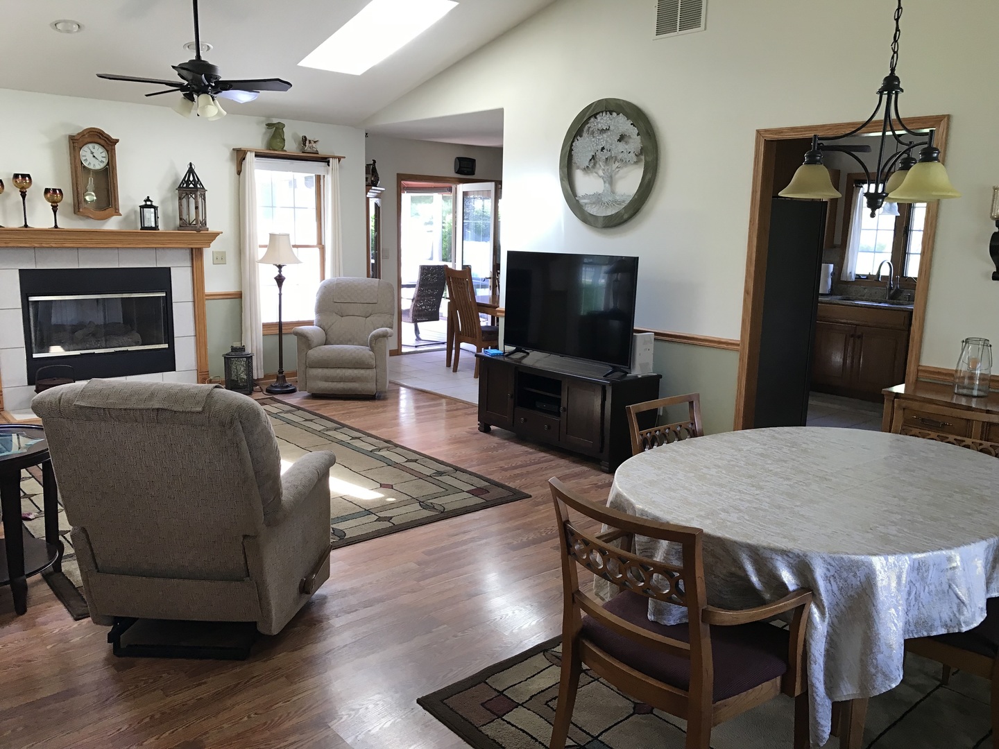 115 Seneca Lane Loda, IL 60948 - Photo 2 of 21 a living room with furniture a clock tv and a window