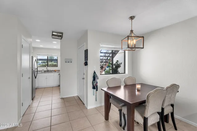 a view of a dining room and a kitchen with a table chairs