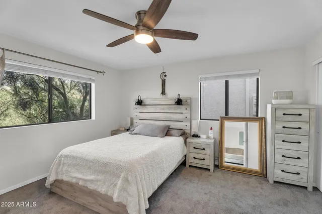 a bedroom with a bed a dresser and a window