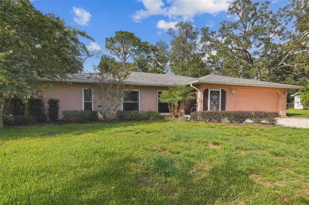 a view of a house with a backyard