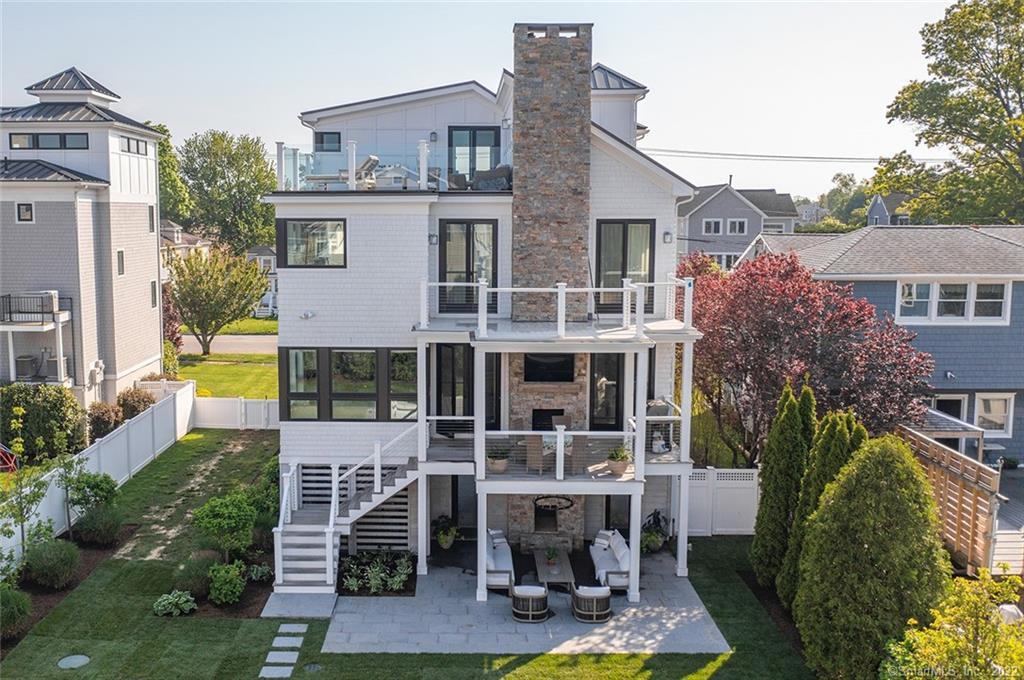 front view of house with a yard and potted plants