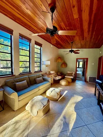 a living room with furniture a couch and large window