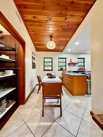 a room with table chairs and a ceiling fan