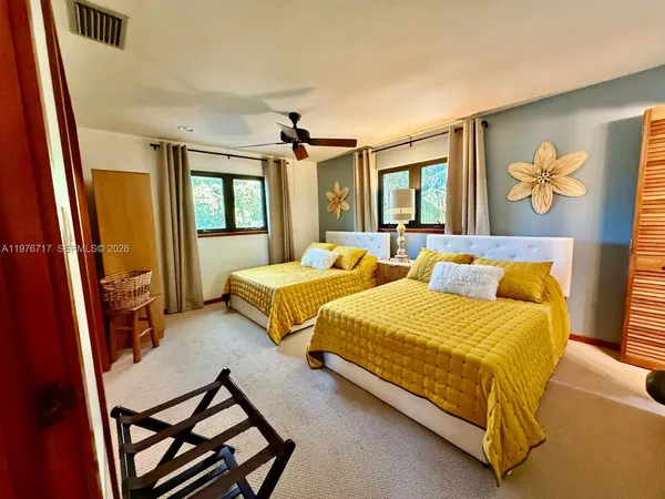 a bedroom with bed and window