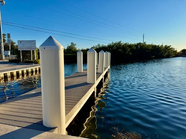 a view of a balcony with chairs and wooden floor