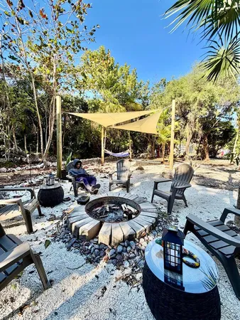a view of a swimming pool with lawn chairs under an umbrella