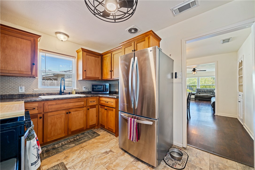 3651 Lawnview Street Corpus Christi, TX 78411 - Photo 16 of 38 a kitchen with stainless steel appliances granite countertop a refrigerator a stove top oven a sink and dishwasher
