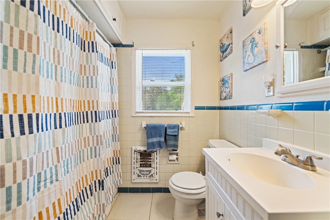 3651 Lawnview Street Corpus Christi, TX 78411 - Photo 18 of 38 a bathroom with a sink toilet and window