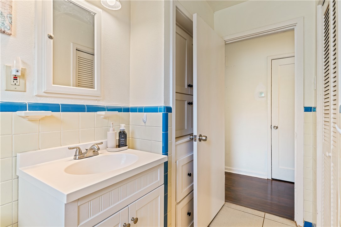 3651 Lawnview Street Corpus Christi, TX 78411 - Photo 19 of 38 a bathroom with a sink a vanity and a mirror