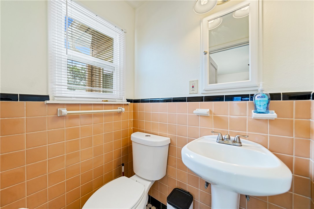 3651 Lawnview Street Corpus Christi, TX 78411 - Photo 24 of 38 a bathroom with a toilet a sink and mirror