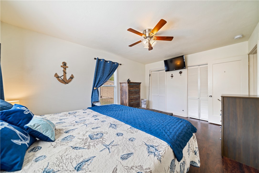 3651 Lawnview Street Corpus Christi, TX 78411 - Photo 27 of 38 a bedroom with a large bed and a chandelier