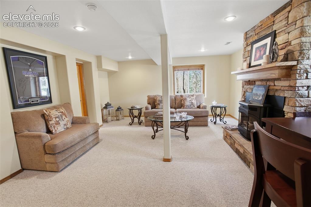 877 North Mountain Estates Road Florissant, CO 80816 - Photo 10 of 23 a living room with furniture and a fireplace