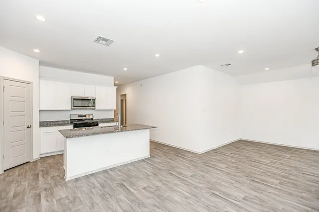 a view of kitchen with a sink and wooden floor