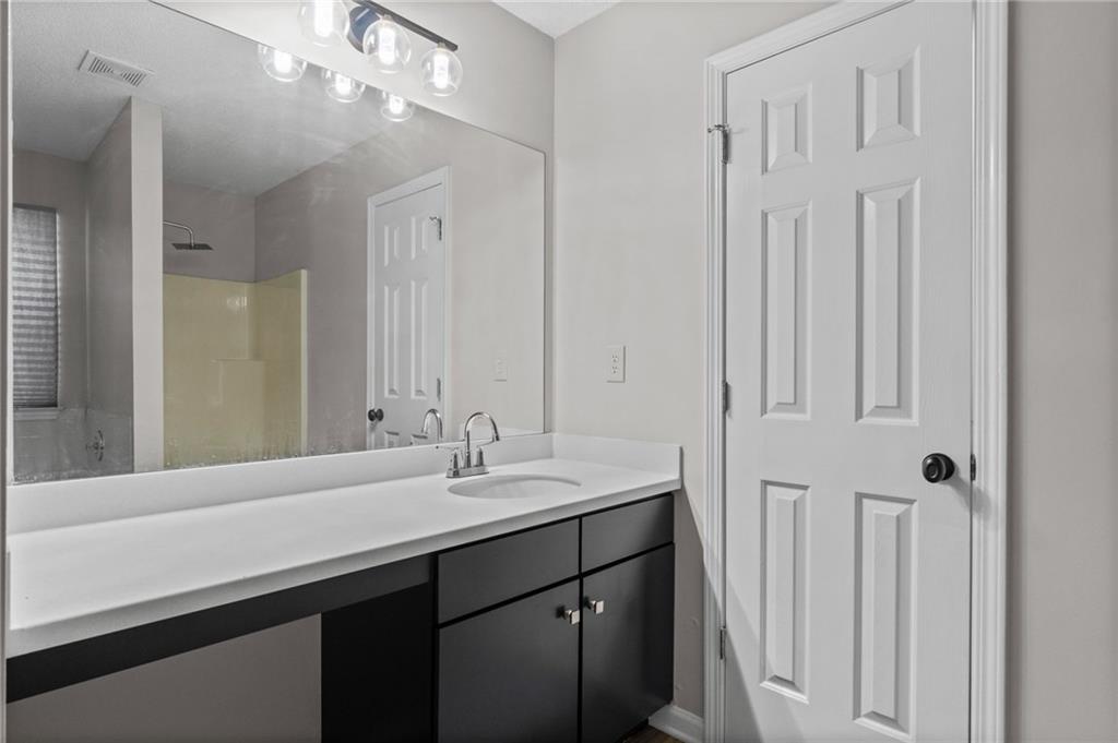 2921 Ward Lake Way Ellenwood, GA 30294 - Photo 17 of 25 a bathroom with a double vanity sink and a mirror