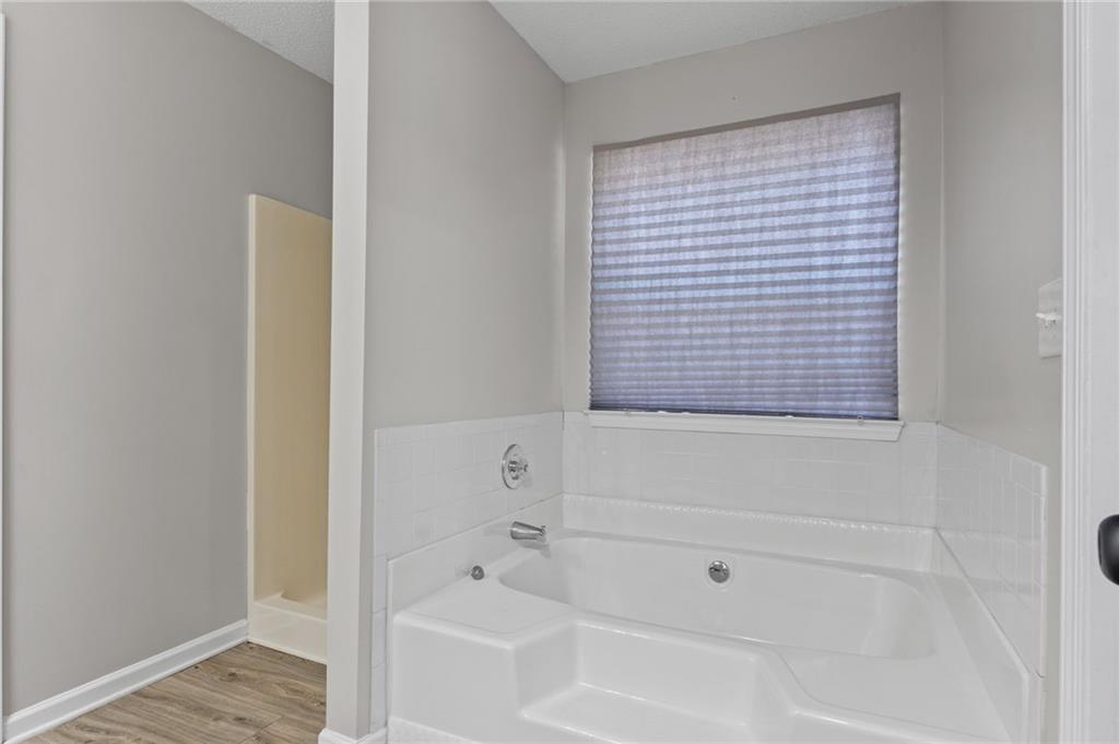 2921 Ward Lake Way Ellenwood, GA 30294 - Photo 18 of 25 a bathroom with a bathtub
