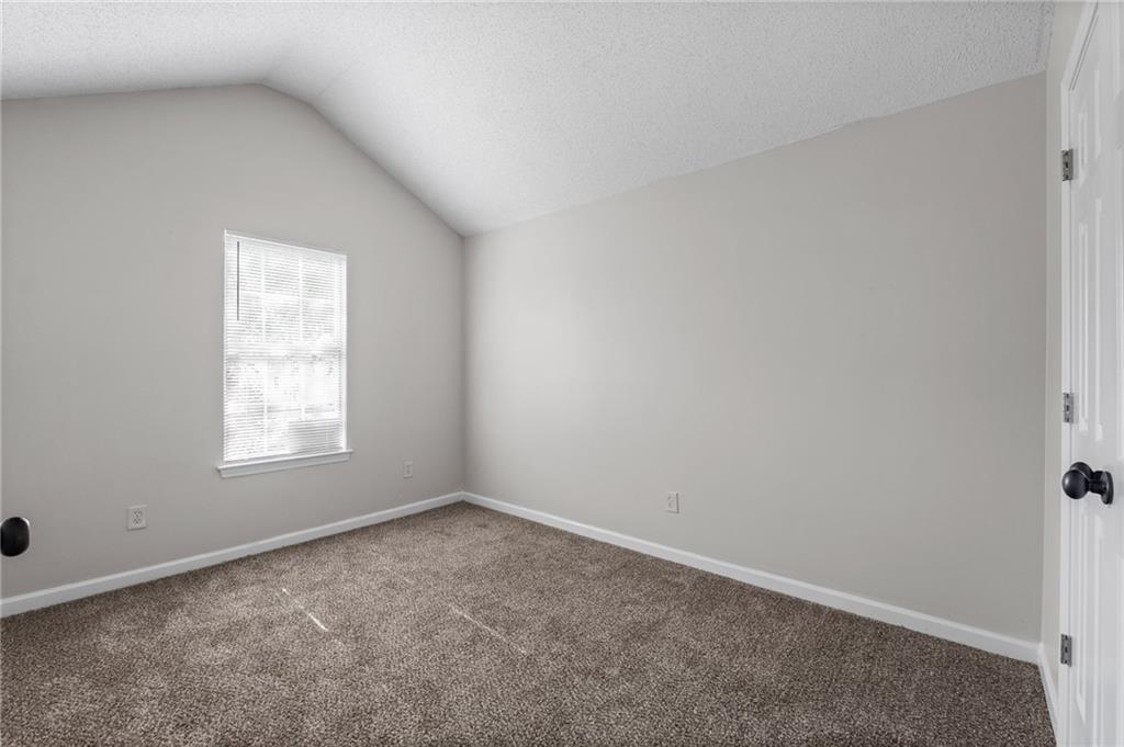 2921 Ward Lake Way Ellenwood, GA 30294 - Photo 21 of 25 an empty room with a window