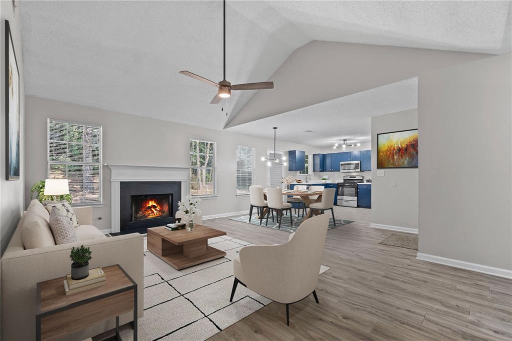 2921 Ward Lake Way Ellenwood, GA 30294 - Photo 6 of 25 a living room with furniture and a fireplace