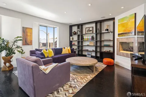 a view of a livingroom with furniture and a book shelf