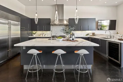 a kitchen with a sink stove top oven and cabinets