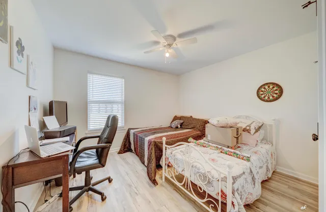 a bedroom with a bed and a chair