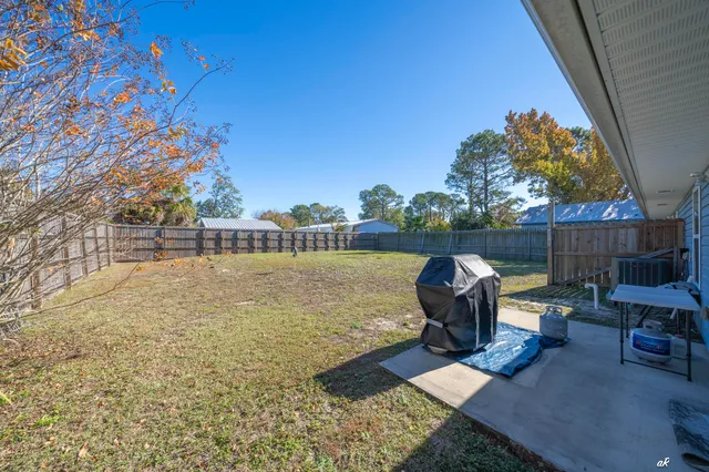 a roof deck with table and chairs and potted plants