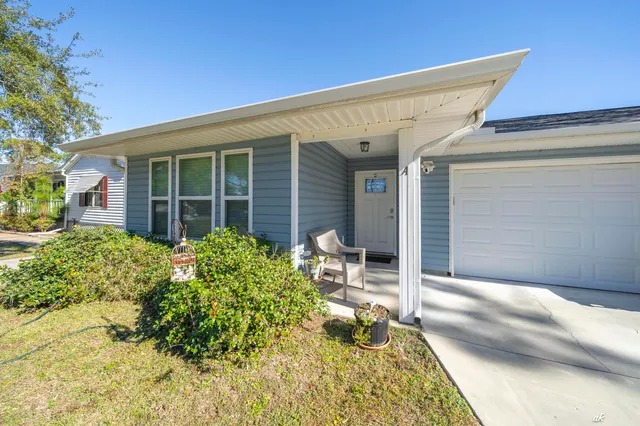 a backyard of a house with outdoor seating