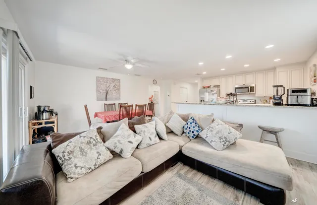 a living room with furniture and kitchen view