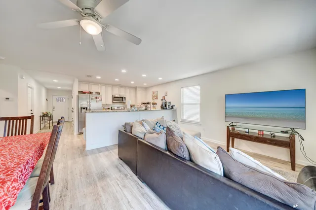 a open kitchen with stainless steel appliances granite countertop a stove and a wooden floors