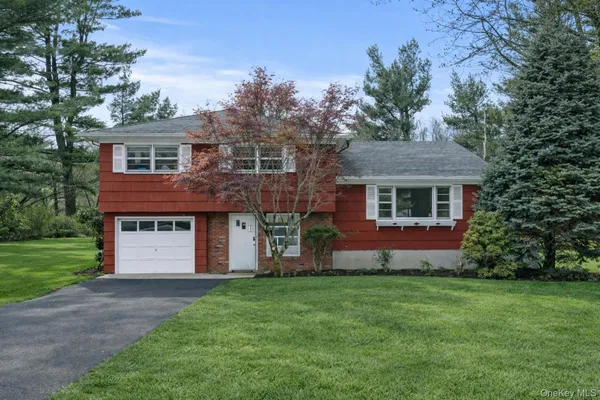 a front view of a house with a garden and plants