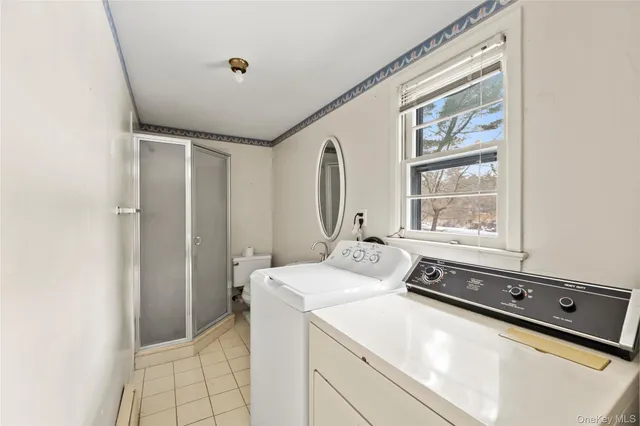 a view of a chairs in a big yard with large trees