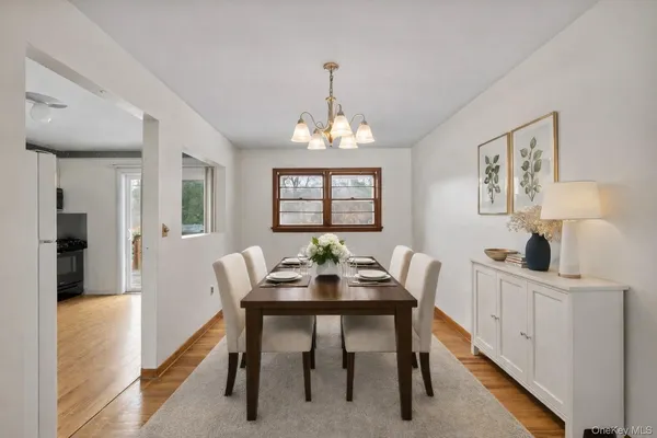 a dining room with furniture a rug and a chandelier