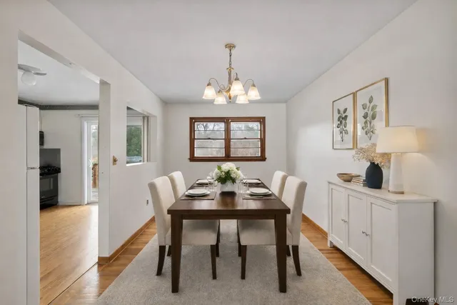 a view of a hallway with wooden floor and entryway