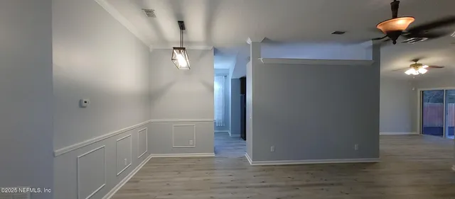a view of a room with wooden floor