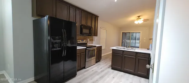 a kitchen with a refrigerator stove and sink