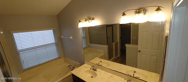 a bathroom with a sink and mirror