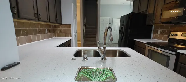 an empty room with wooden floor and window