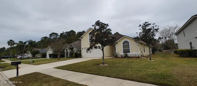 a view of house with yard