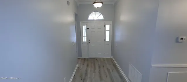 a view of entryway with wooden floor