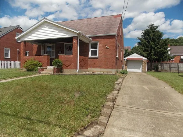a front view of a house with a yard and porch