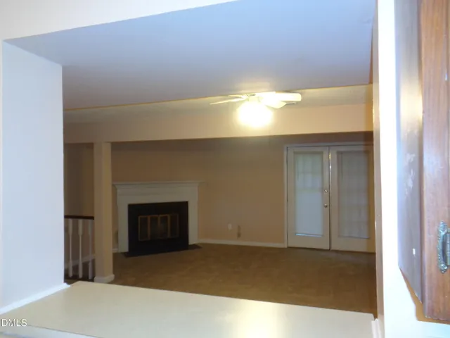 a view of an empty room and fire place