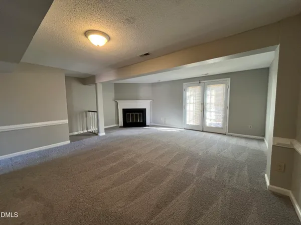 a view of empty room with a fireplace