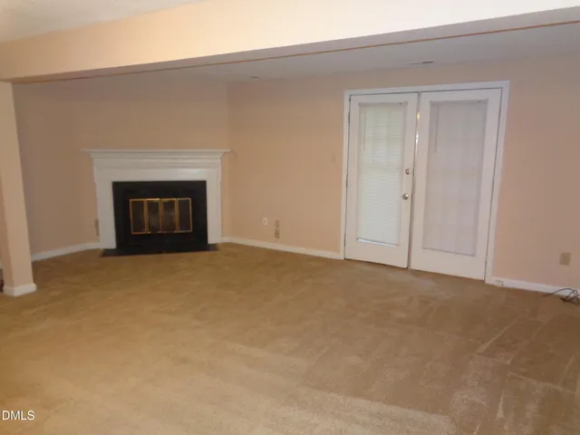 a view of an empty room with a fireplace