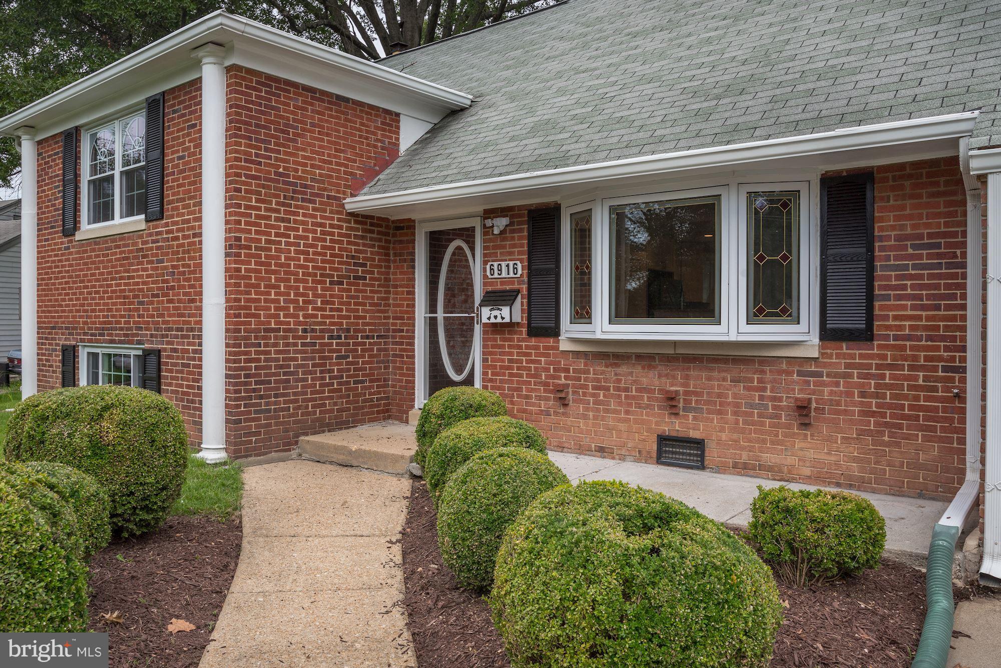 6916 Gilbert Street Springfield, VA 22150 - Photo 2 of 26 a front view of a house with a yard
