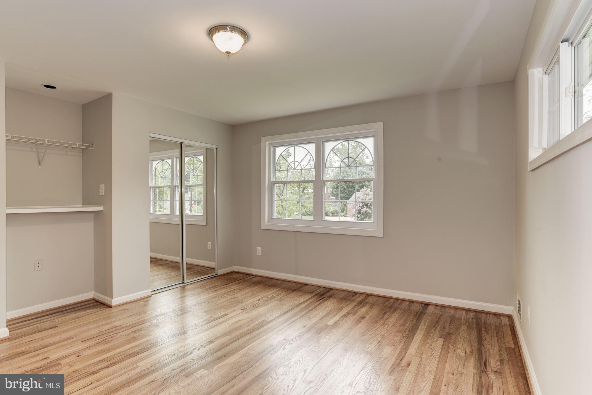 6916 Gilbert Street Springfield, VA 22150 - Photo 12 of 26 an empty room with wooden floor and windows