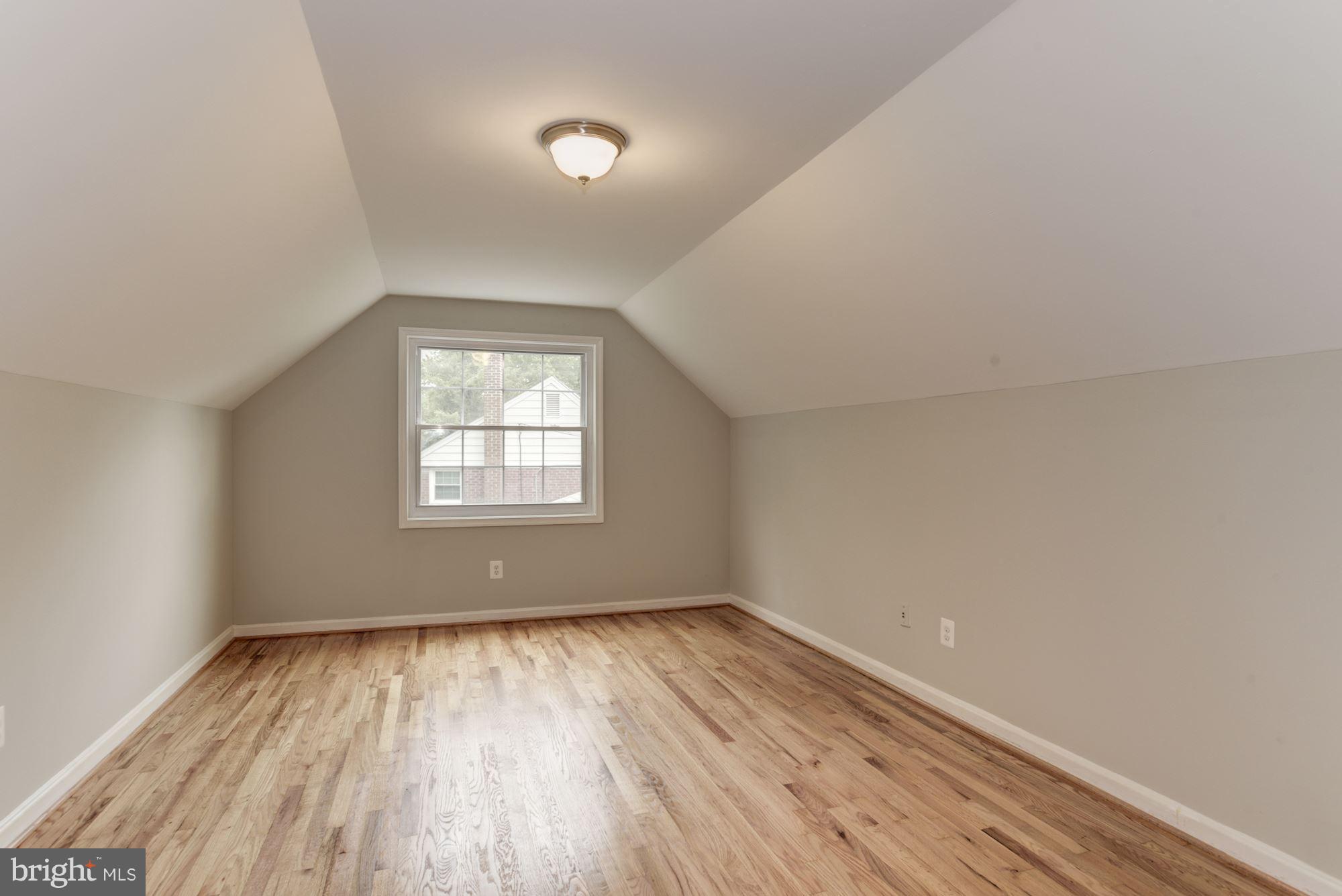 6916 Gilbert Street Springfield, VA 22150 - Photo 13 of 26 an empty room with wooden floor and windows